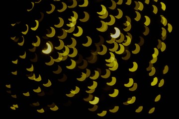 Gold glitter fish scale bokeh sequin confetti on black background © Rawpixel.com