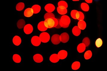 Red glitter bokeh sequin confetti on black background