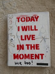 Today I will live in the moment sign on public wall