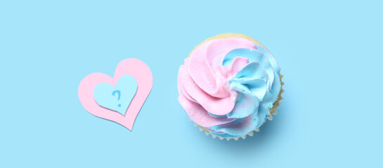 Delicious cupcake with question mark on blue background. Gender reveal party concept