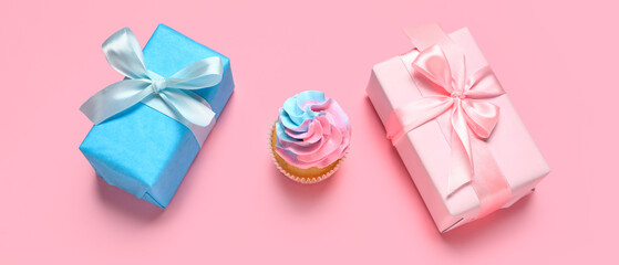 Delicious cupcake with gift boxes on pink background. Gender reveal party concept