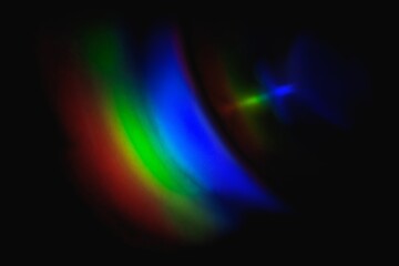 Neon lens flare prism rainbow light reflection on black background