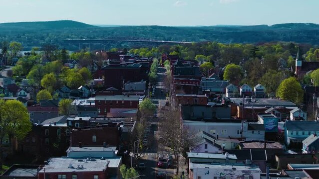 This is a Mavic 3 Pro drone shot using the 70mm lens of Beacon, NY's Main Street with the Newburgh-Beacon Bridge in the background. The movement is a simple "dolly in" push forward towards the river.