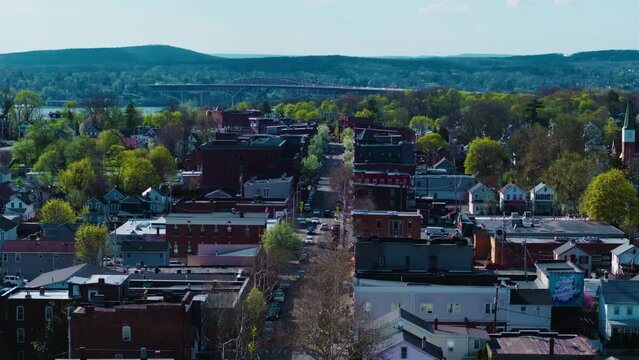 This is a Mavic 3 Pro drone shot using the 70mm lens of Beacon, NY's Main Street with the Newburgh-Beacon Bridge in the background. The movement is an orbit to the right.