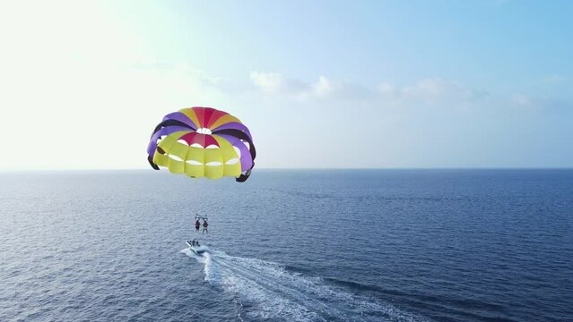 Back View of Double Parasailing Canopy Tugged by Motorboat, Drone Wide Shot