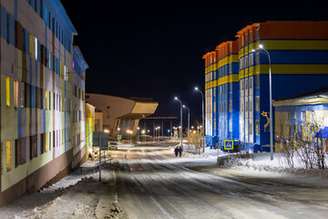 Anadyr city, Chukotka, Russia - April 14, 2023. Evening city landscape. View of the street and...