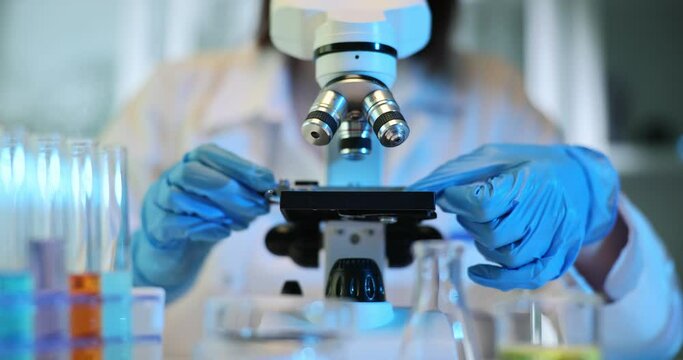 Closeup of microscope with lens and laboratory glass setup - Powered by Adobe