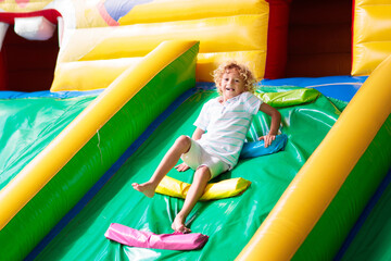 Child jumping on playground trampoline. Kids jump.