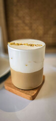 Fresh iced coffee in glass with frothy cream for your design, Food concept in style, copy space