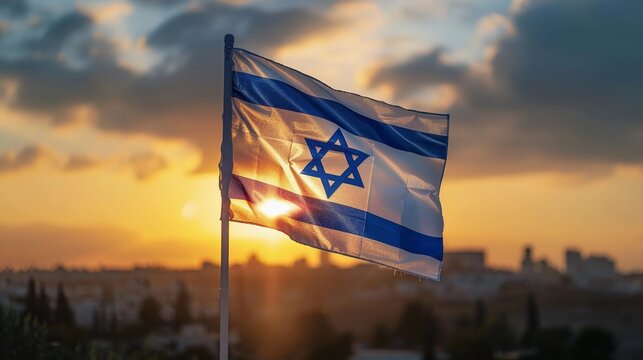 Solemn Israel flag fluttering at dusk with soft focus background. Yom HaZikaron, Israel Independence Day, Memorial Day for Fallen Soldiers and Victims of Terrorism