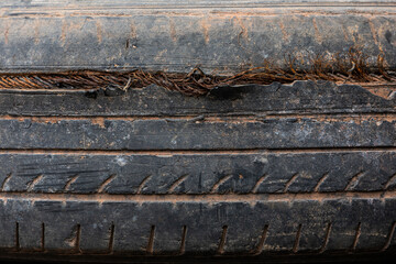 Old tires stacked in a heap, forming a textured pattern