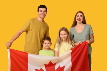 Happy family with flag of Canada on yellow background