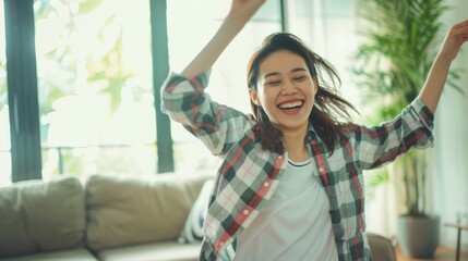 Young happy asian woman dancing at home.