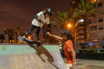 Skateboarding coach with his student at the skate park