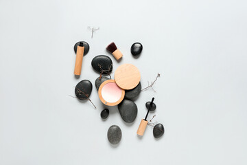 Highlighter with mascara, twigs and stones on white background. Eco style concept