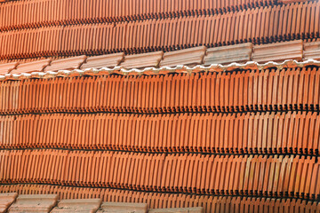 Red clay roof tiles for vintage looking house made of natural eco friendly building material.  Clay...