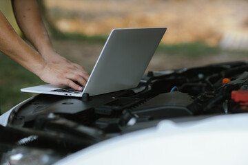 Modern mechanics use laptop computers to check engines. Gather detailed information during work. Industrial plant maintenance services Until engine repair in factories, transportation, cars, vehicles