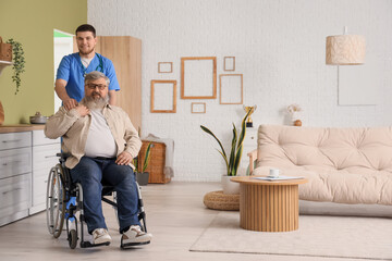Senior man in wheelchair with caregiver at home