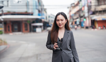 Beautiful woman going to work, businesswoman holding laptop with a cup of coffee