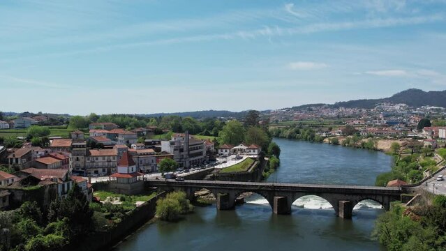 Barcelos cityscape with medieval bridge over the tranquil Cavado River, Portugal - aerial