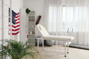 Interior of rehabilitation center with couch and hanging USA flag