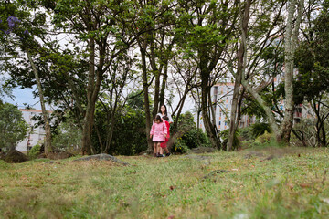 International Children Day. Very happy Latino children playing outdoors, running and smiling. Concept of family and fun. Nature.