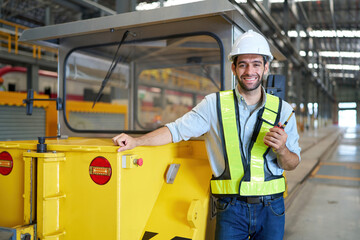 engineer or worker smiling with a car in the factory