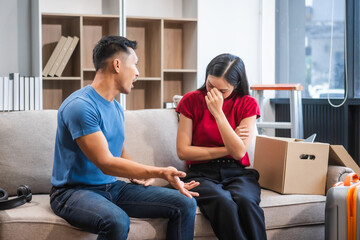 Young Asian couple managing a relocation amidst quarrels and disagreements. Proficient in handling...