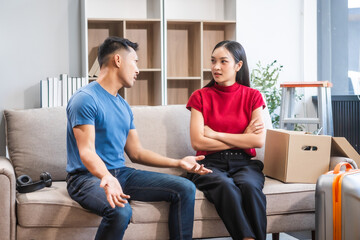 Young Asian couple managing a relocation amidst quarrels and disagreements. Proficient in handling...