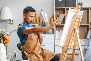 Middle-aged Asian man, skilled painting artist, donning an apron. Proficient in art, creativity, inspiration, and canvas work, utilizing various tools to express imagination.