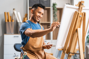 Middle-aged Asian man, skilled painting artist, donning an apron. Proficient in art, creativity,...