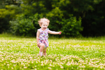 Child in spring park with flowers