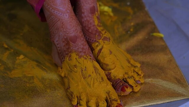 Turmeric Paste On Bride's Feet During Pithi Ceremony Celebration - Close Up
