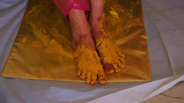 Close Up Of Turmeric Paste On Bride's Feet During Pithi Ceremony Celebration