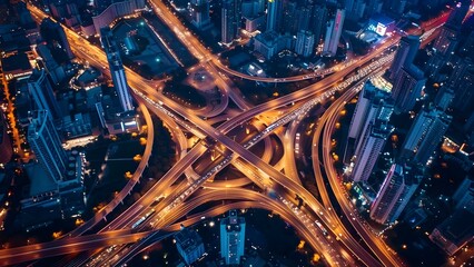 Aerial view of busy expressway intersection in a city at night. Concept Cityscape, Night Photography, Aerial View, Busy Traffic, Urban Intersection