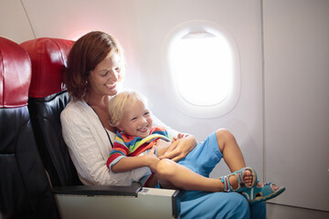 Family in airplane. Mother and child fly.