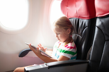 Child flying in airplane. Flight with kids.