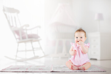 Little baby girl  in white nursery