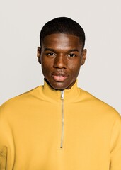 Black man in yellow zip up sweater portrait
