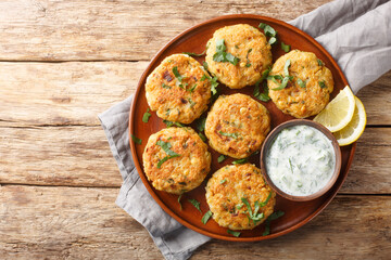 Chickpea Fritters with Yoghurt Dipping Sauce close-up in plate on the table. Horizontal top view...