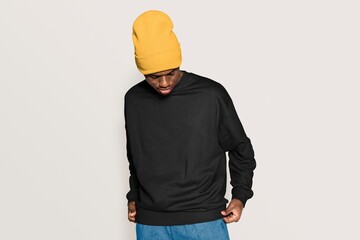 Trendy man in black college sweater and beanie