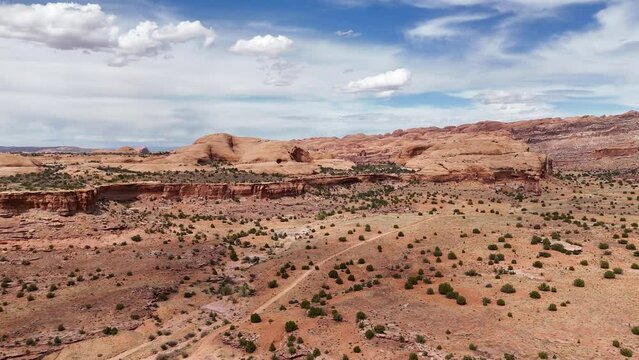 Aerial-Desert dotted with juniper trees to cliffs and domes