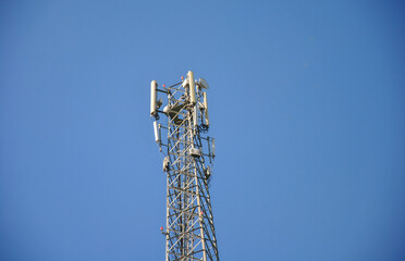 cell phone tower. mobile phone tower against a clear blue sky