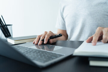 Businessperson or student studying or learning with laptop and book at home. Success or achievement idea concept of education knowledge or skill development training course online and cognition.