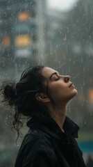 A woman standing in the rain with her eyes closed