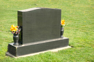 Large tombstone with flowers and space for a message.