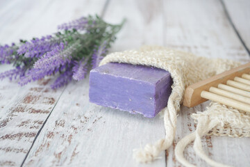 Homemade natural soap bar and lavender flower on table 