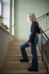 Studio portrait of a young beautiful blonde long-haired girl.