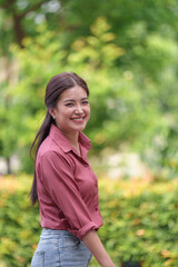 Fototapeta premium Business woman, independent woman, lifestyle, standing Walk and smile while working outside the workplace. nature, coffee shop Take up hobbies and online internet meetings during the holidays.