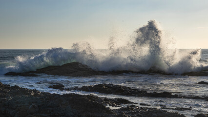 waves crashing onto rocks at minnie water durinng sunrise